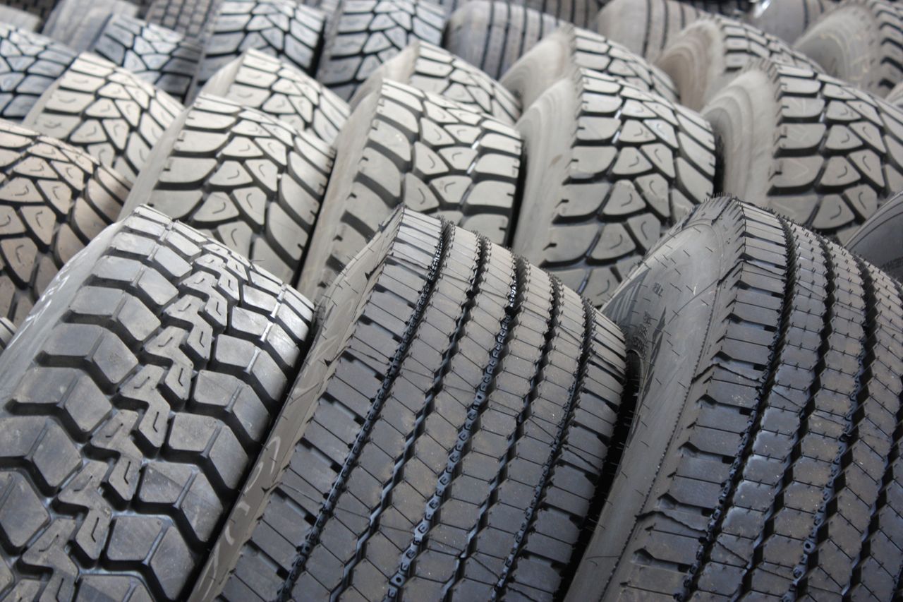 our-story-01 High-quality image of stacked industrial tires showcasing tread patterns.