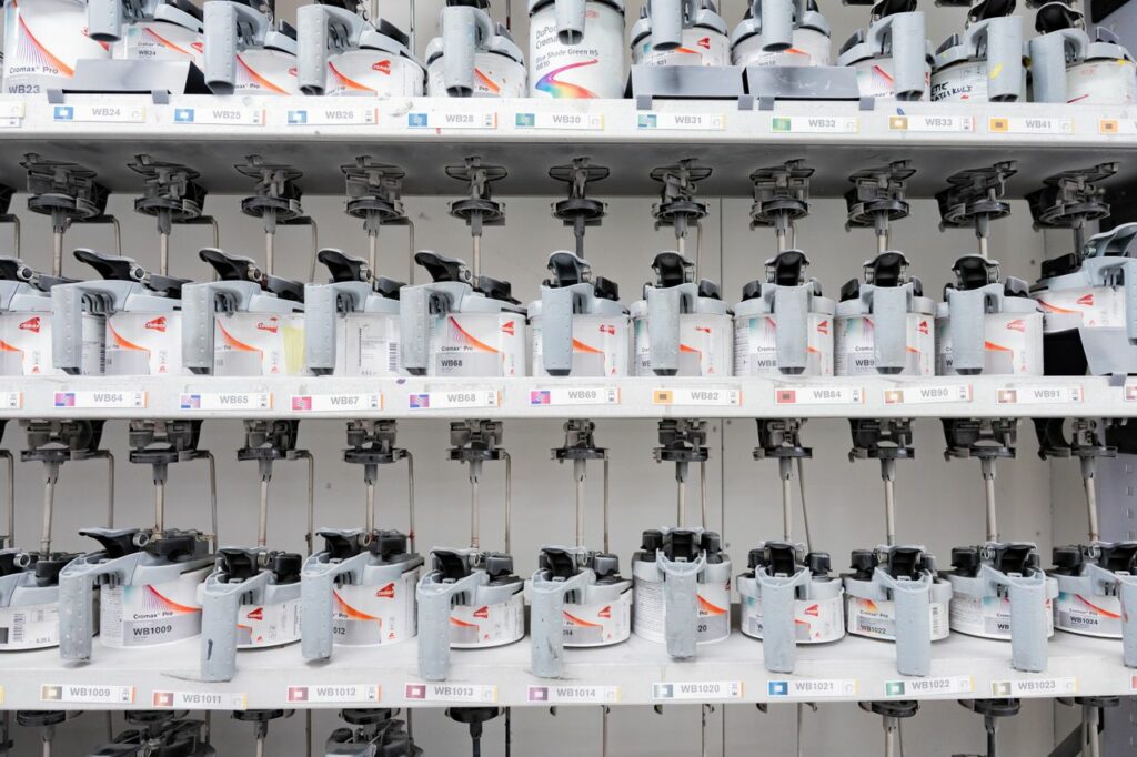 Mastering the First Impression: Your intriguing post title goes here Organized industrial paint mixer station with multiple dispensers for accurate color mixing.
